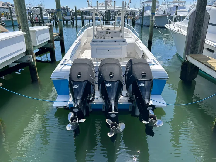 Overboard Yacht Photos Pics 2005 Intrepid 370 Cuddy boat with triple outboard engines docked at marina.