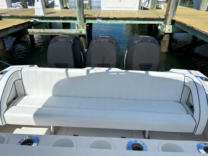 Overboard Yacht Photos Pics 2005 Intrepid 370 Cuddy boat with triple outboard engines at dock.