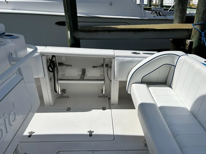 Overboard Yacht Photos Pics 2005 Intrepid 370 Cuddy boat interior with white seating and storage compartments.