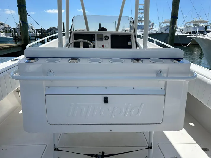 Overboard Yacht Photos Pics 2005 Intrepid 370 Cuddy boat cockpit with steering wheel and control panel.