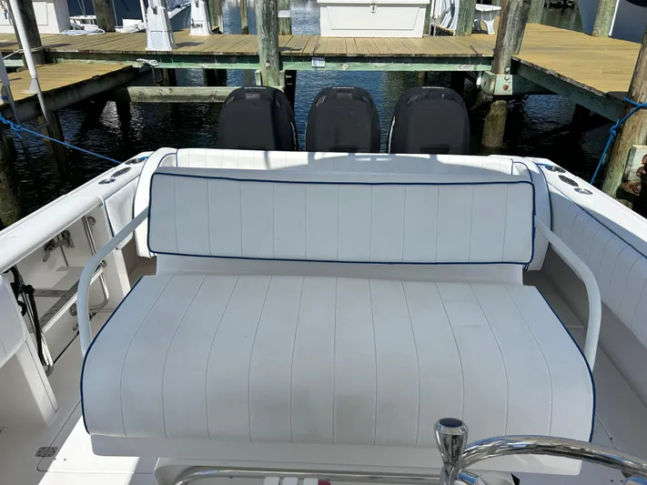 Overboard Yacht Photos Pics 2005 Intrepid 370 Cuddy boat with white seating at dock.