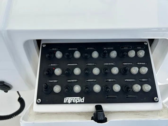 Overboard Yacht Photos Pics Control panel of a 2005 Intrepid 370 Cuddy boat with labeled switches.
