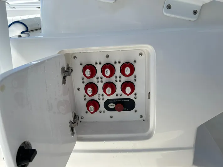 Overboard Yacht Photos Pics Electrical panel on a 2005 Intrepid 370 Cuddy boat with red circuit switches.