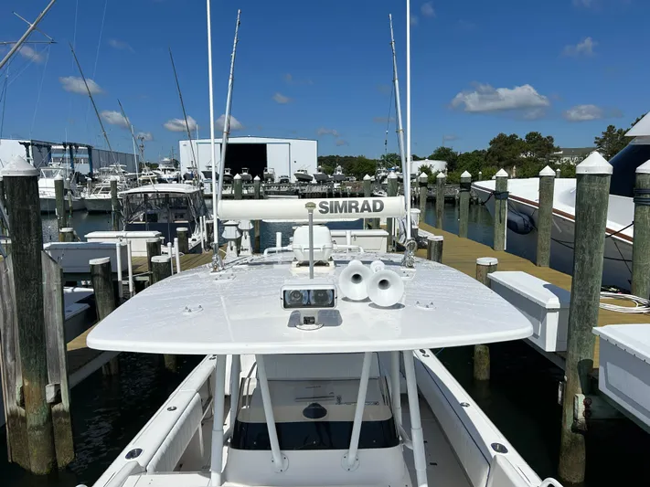 Overboard Yacht Photos Pics 2005 Intrepid 370 Cuddy boat docked at a marina with clear blue sky.