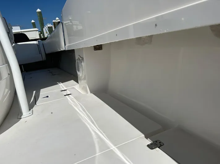 Overboard Yacht Photos Pics 2005 Intrepid 370 Cuddy boat interior, clean white deck and seating area.