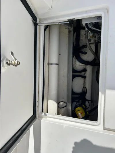 Overboard Yacht Photos Pics Open storage compartment on a 2005 Intrepid 370 Cuddy boat showing internal components.