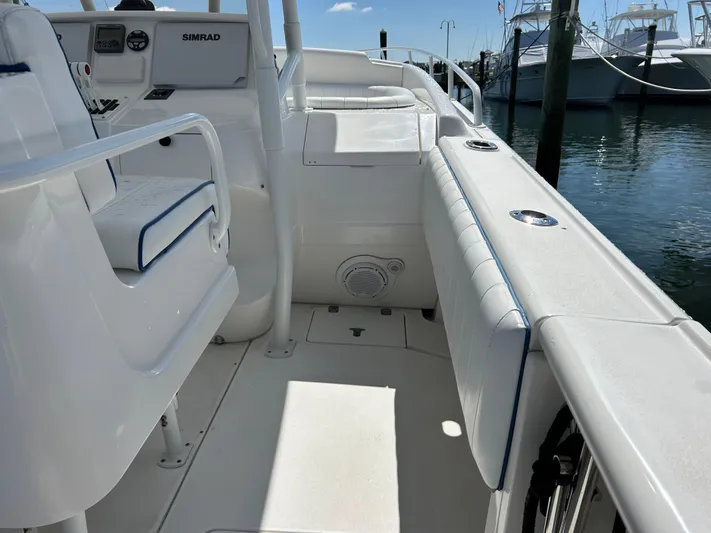 Overboard Yacht Photos Pics 2005 Intrepid 370 Cuddy boat interior with white seating and Simrad navigation system.