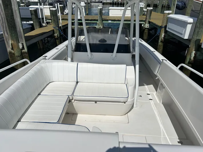 Overboard Yacht Photos Pics 2005 Intrepid 370 Cuddy boat with white seating at a marina dock.