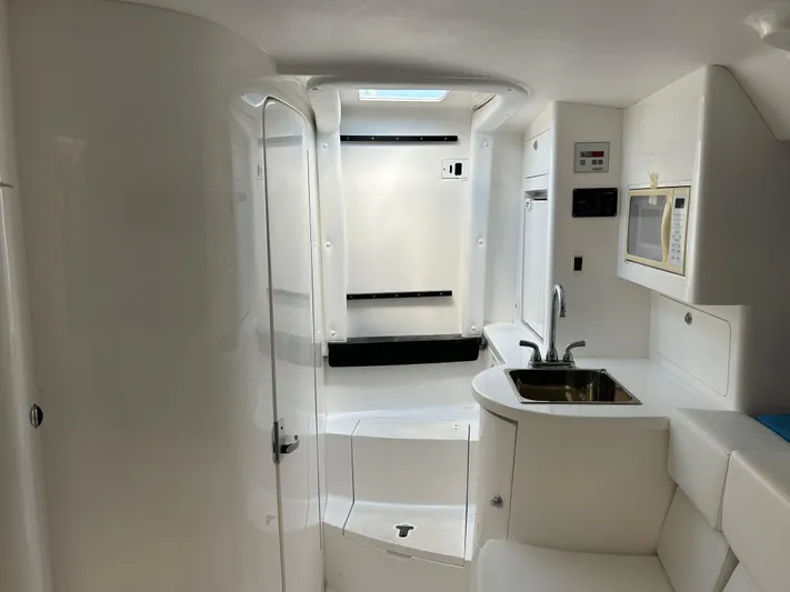 Overboard Yacht Photos Pics Interior of a 2005 Intrepid 370 Cuddy boat with sink and microwave.