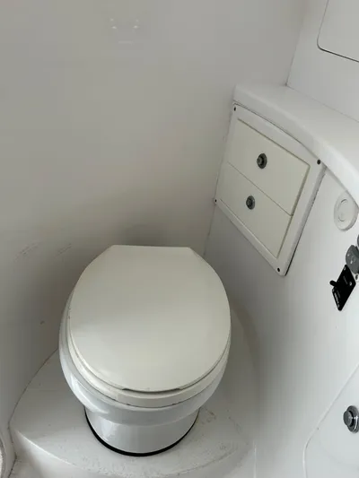 Overboard Yacht Photos Pics Boat bathroom with toilet and storage on a 2005 Intrepid 370 Cuddy.