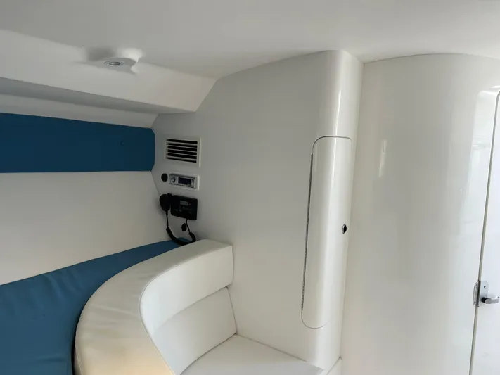 Overboard Yacht Photos Pics Interior cabin of a 2005 Intrepid 370 Cuddy boat with seating and communication equipment.