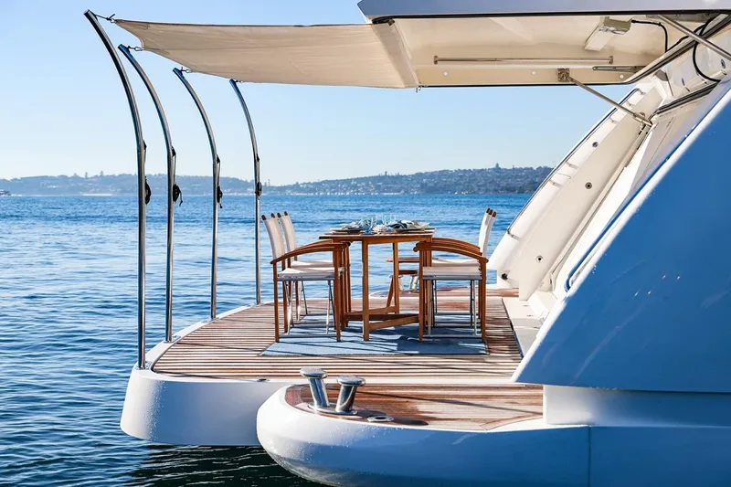 Frivolous Yacht Photos Pics Luxury Sunseeker 34 Metre Yacht 2009 with elegant outdoor dining area on serene water.