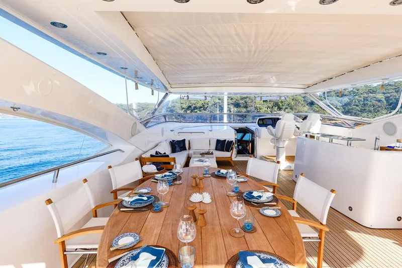 Frivolous Yacht Photos Pics Luxurious Sunseeker 34 Metre Yacht 2009 with elegant outdoor dining area and ocean view.