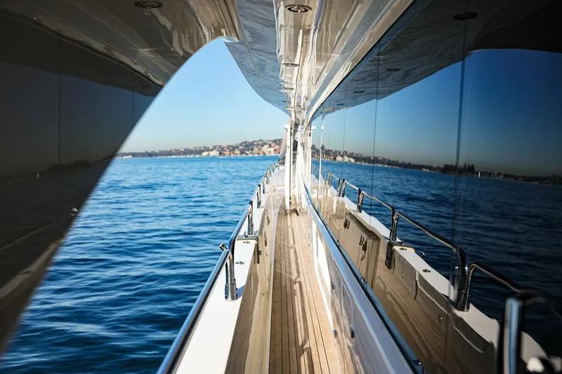 Frivolous Yacht Photos Pics Side view of a 2009 Sunseeker 34 Metre Yacht cruising on blue waters.