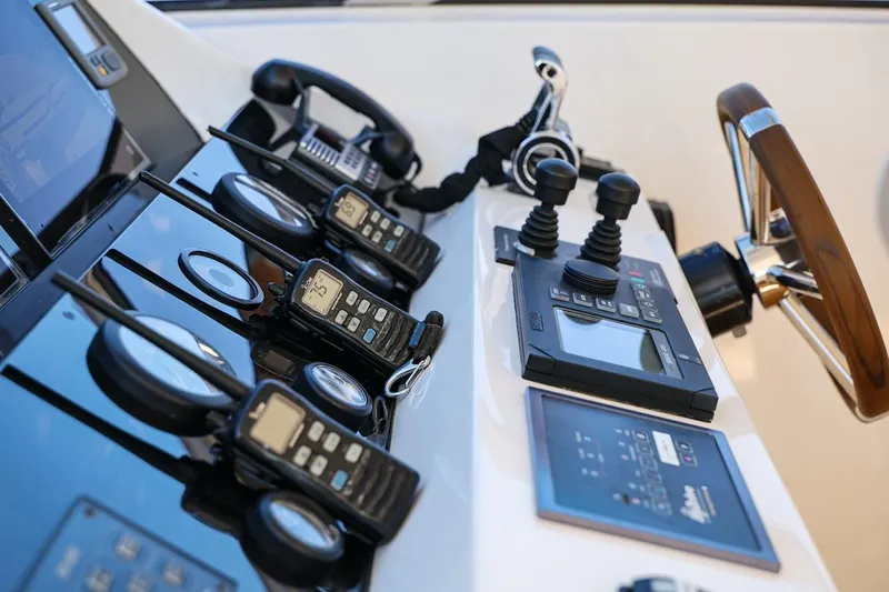 Frivolous Yacht Photos Pics Control panel of a 2009 Sunseeker 34 Metre Yacht with communication devices and steering wheel.