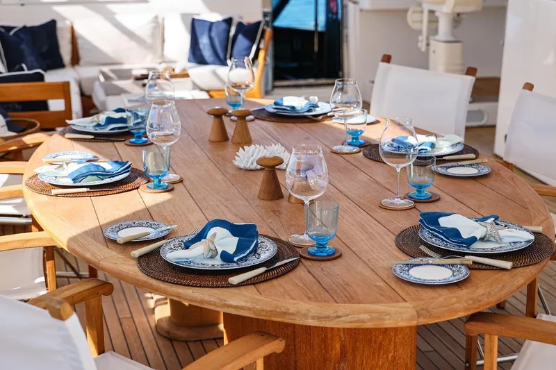 Frivolous Yacht Photos Pics Elegant dining setup on 2009 Sunseeker 34 Metre Yacht, featuring blue and white tableware.