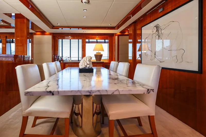 Frivolous Yacht Photos Pics Luxurious dining area on 2009 Sunseeker 34 Metre Yacht with marble table and elegant decor.