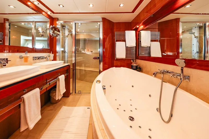 Frivolous Yacht Photos Pics Luxurious bathroom on a 2009 Sunseeker 34 Metre Yacht with jacuzzi and elegant wood finishes.