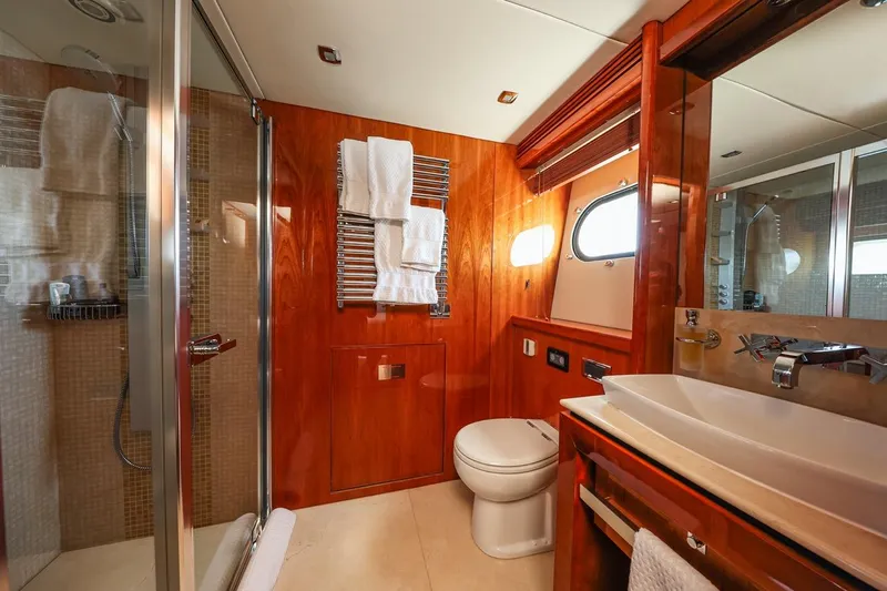 Frivolous Yacht Photos Pics Luxurious bathroom on 2009 Sunseeker 34 Metre Yacht with wood accents and modern fixtures.