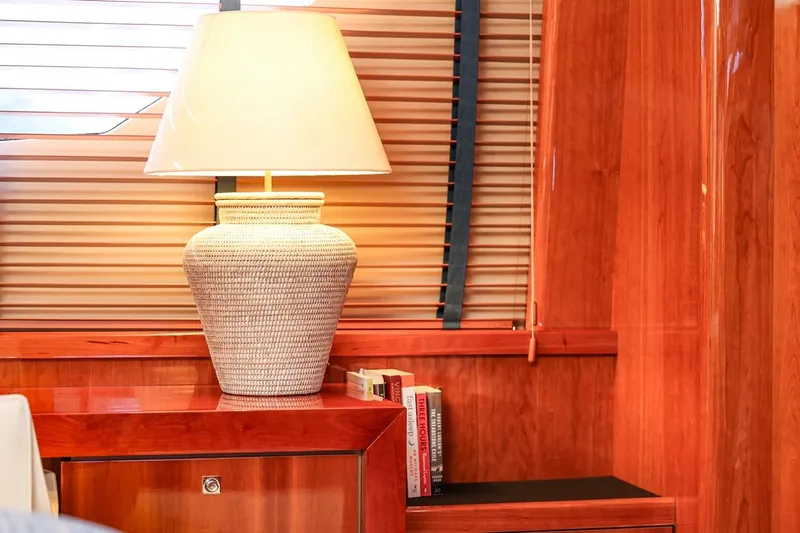 Frivolous Yacht Photos Pics Luxurious yacht interior with wooden paneling, elegant lamp, and books on a Sunseeker 34 Metre Yacht.