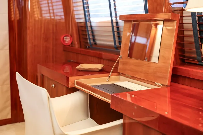 Frivolous Yacht Photos Pics Luxurious wooden vanity area on 2009 Sunseeker 34 Metre Yacht with white chair.