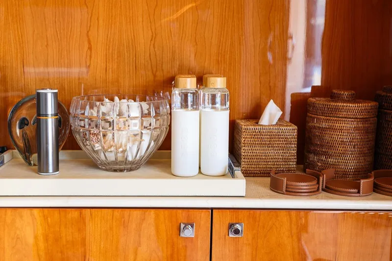 Frivolous Yacht Photos Pics Luxury yacht interior with elegant wooden cabinetry, glass bowl, and wicker baskets on Sunseeker 34 Metre Yacht.