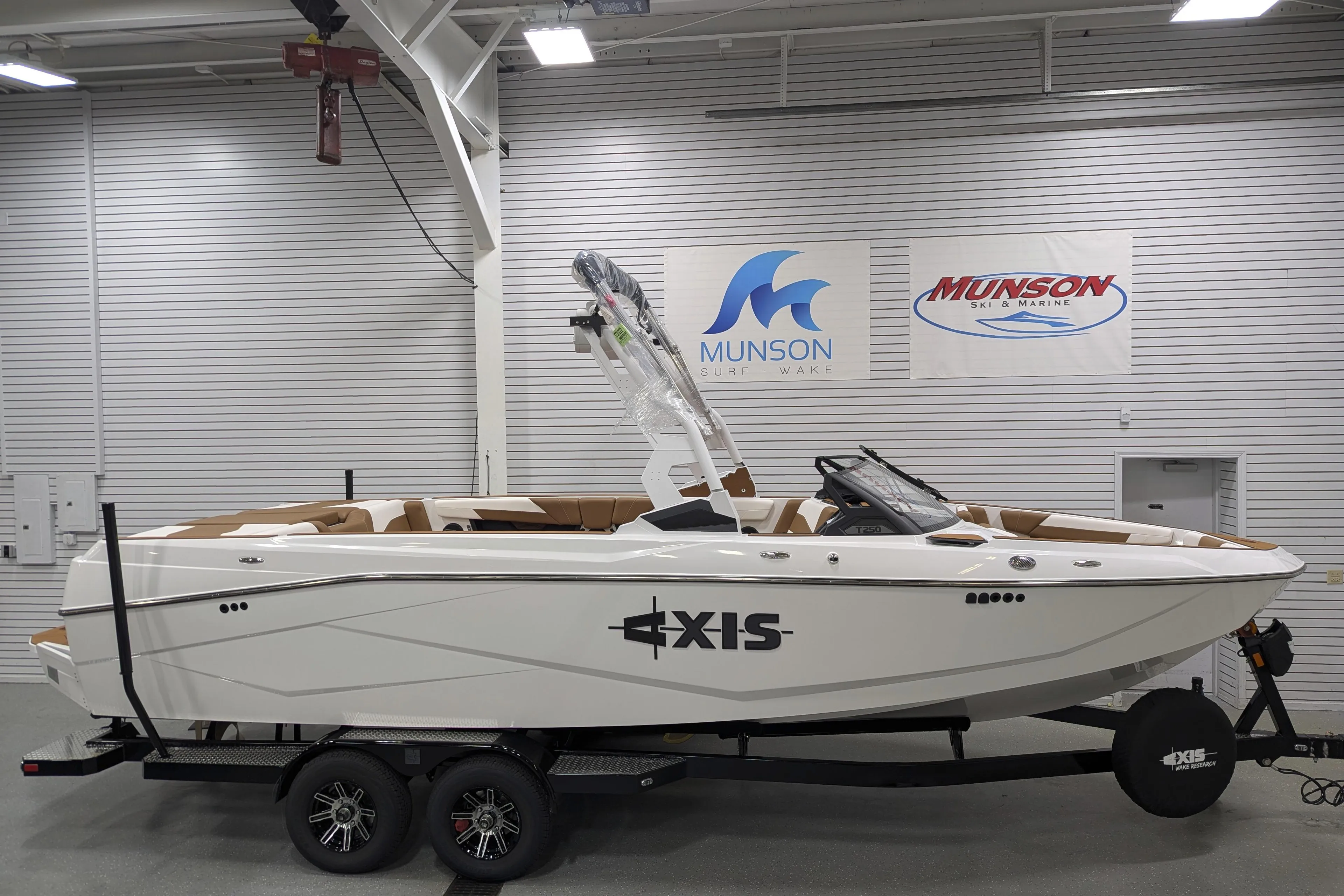 2026 Axis T250 boat in showroom, displayed on trailer, Munson Ski & Marine signage.