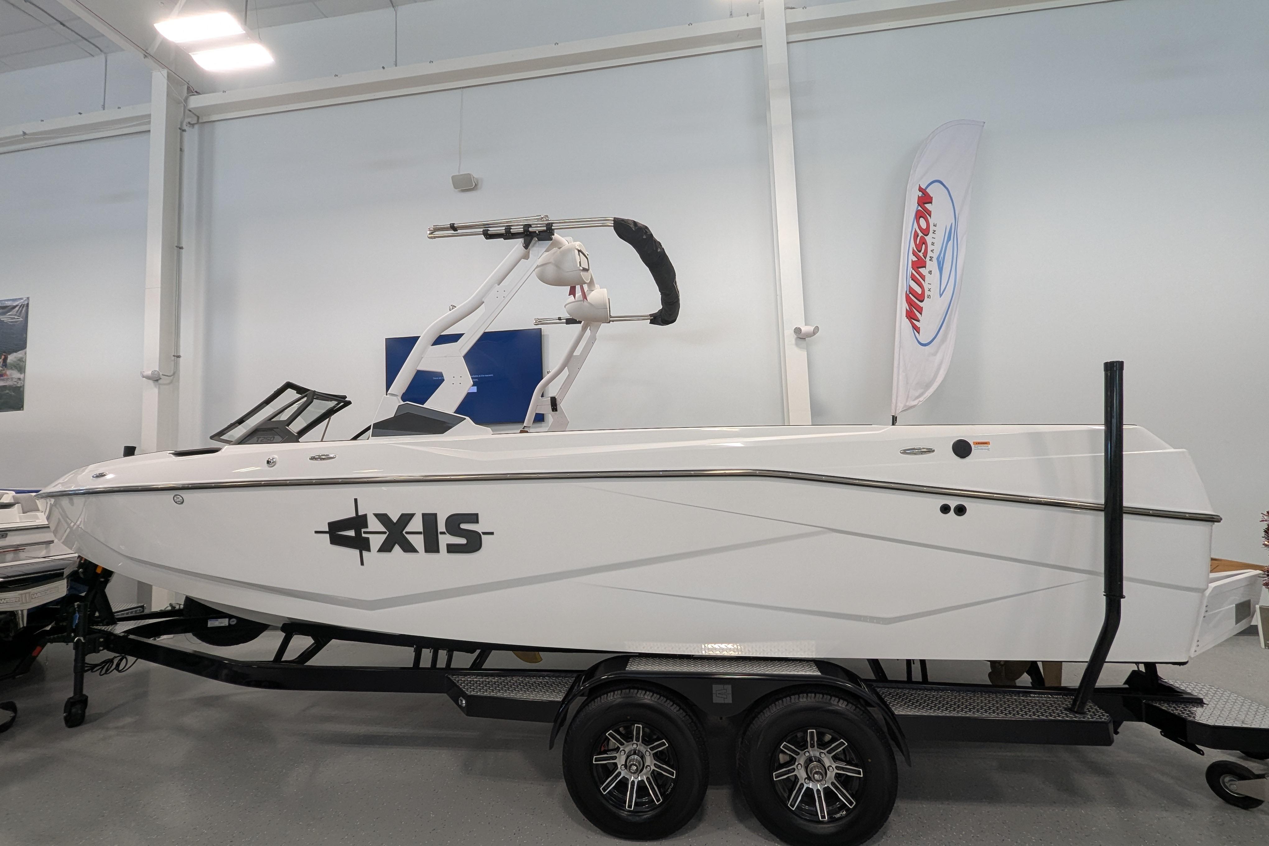 2026 Axis T250 boat on trailer in showroom, featuring sleek design and modern wakeboard tower.