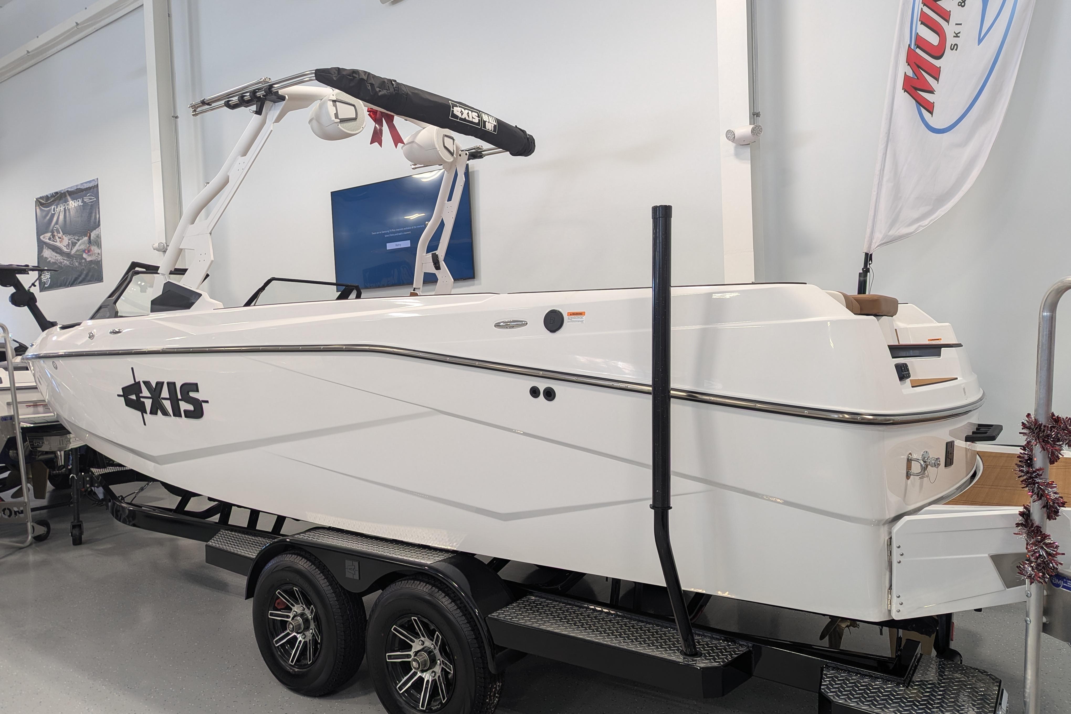 2026 Axis T250 boat on trailer in showroom, white exterior, sleek design.