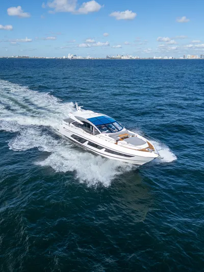 1031-ex Yacht Photos Pics 2020 Sunseeker Predator 74 yacht cruising on open sea under blue sky.