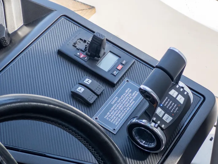 1031-ex Yacht Photos Pics Control panel of 2020 Sunseeker Predator 74 yacht with throttle and switches.