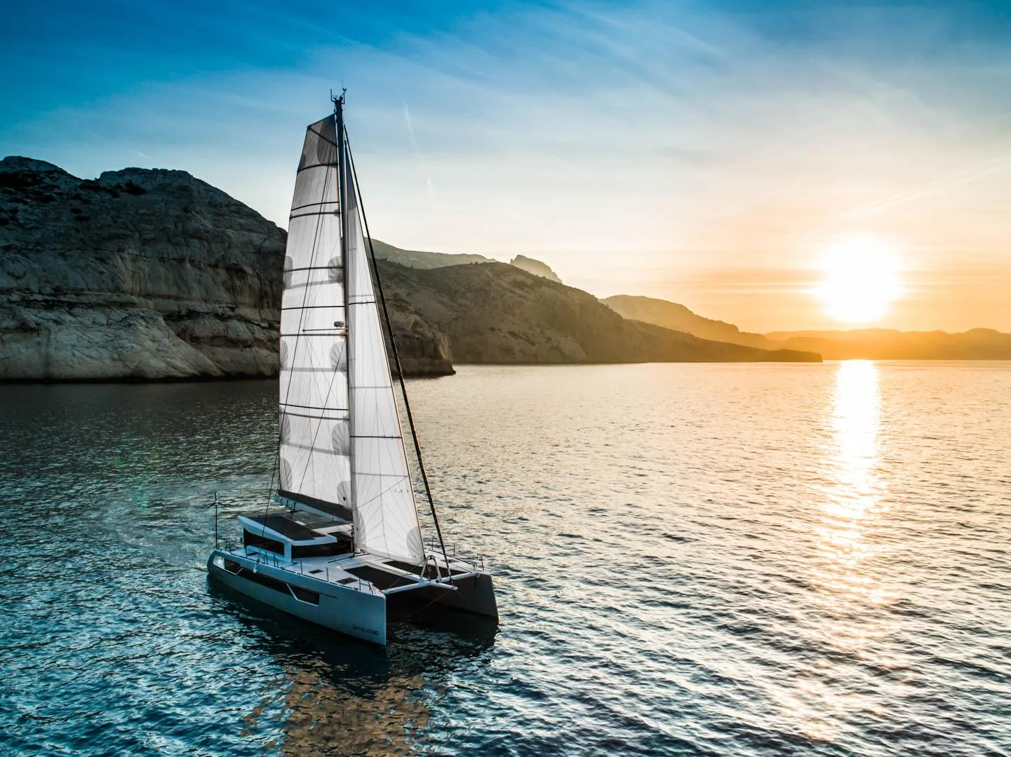 Windelo 54 sailboat cruising at sunset in 2025.