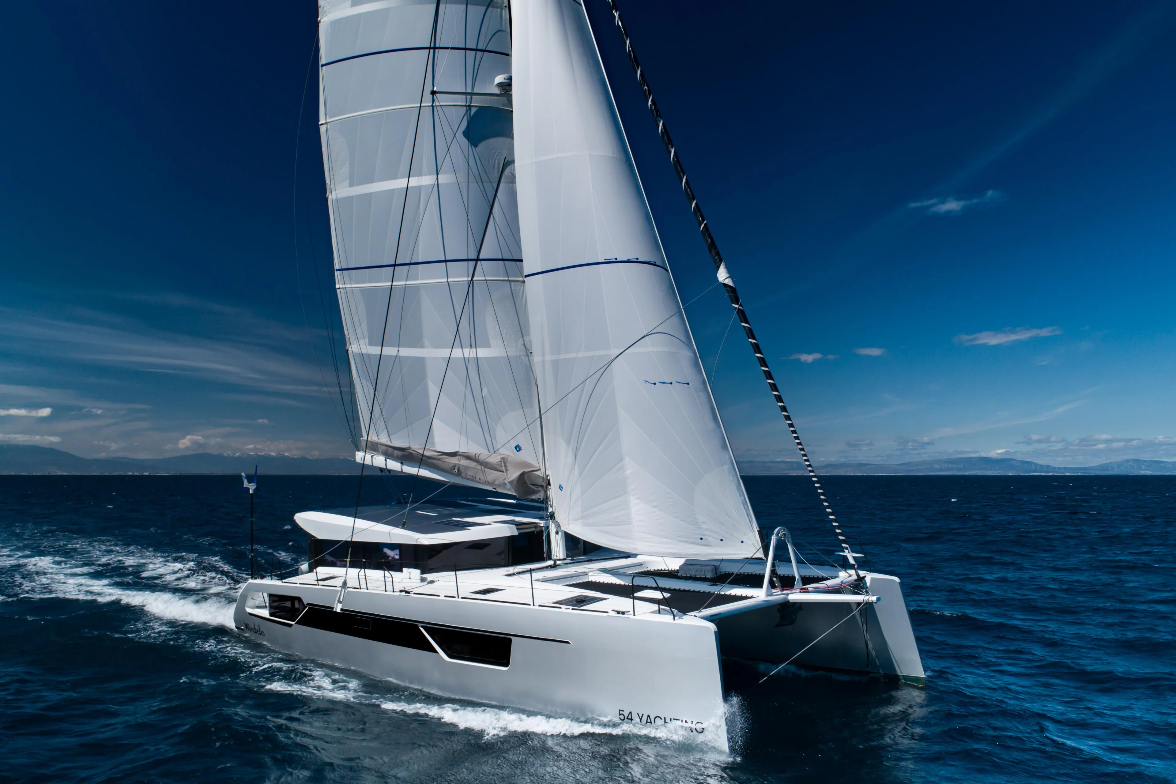 Windelo 54 catamaran sailing on open sea, 2025 model.