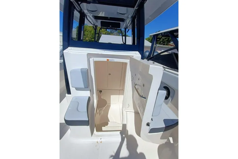 300-115 Yacht Photos Pics 2025 Robalo R300 Center Console boat interior with open storage compartment.