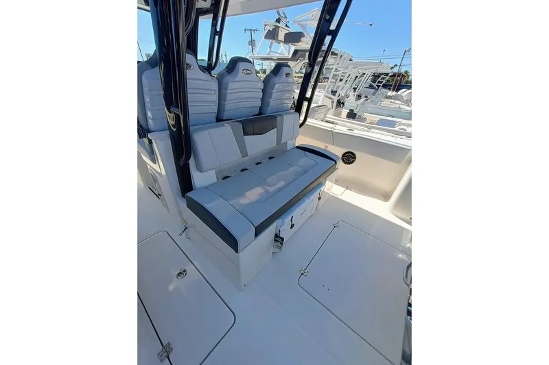 300-115 Yacht Photos Pics 2025 Robalo R300 Center Console boat interior with cushioned seating and storage compartments.