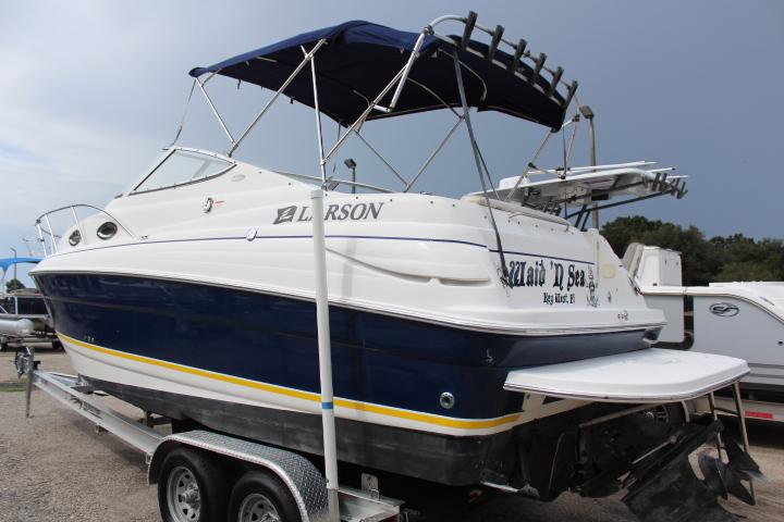 2005 Larson Cabrio 240 boat on trailer with blue and white exterior.