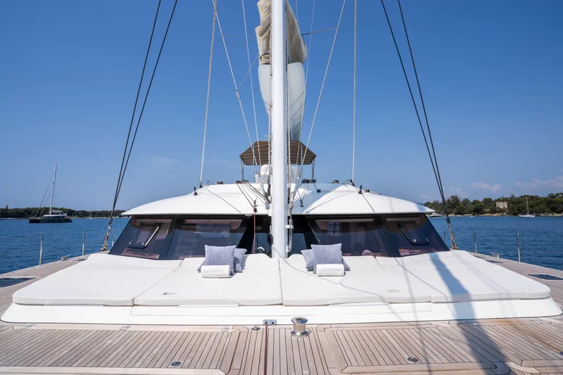 Seazen II Yacht Photos Pics Luxurious 2008 Sunreef 70 yacht deck with cushions, sailing on calm blue waters.