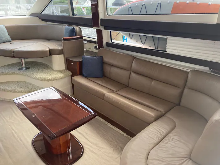 Sea Shack Yacht Photos Pics Luxurious interior of 2013 Meridian 391 yacht with leather seating and wooden table.