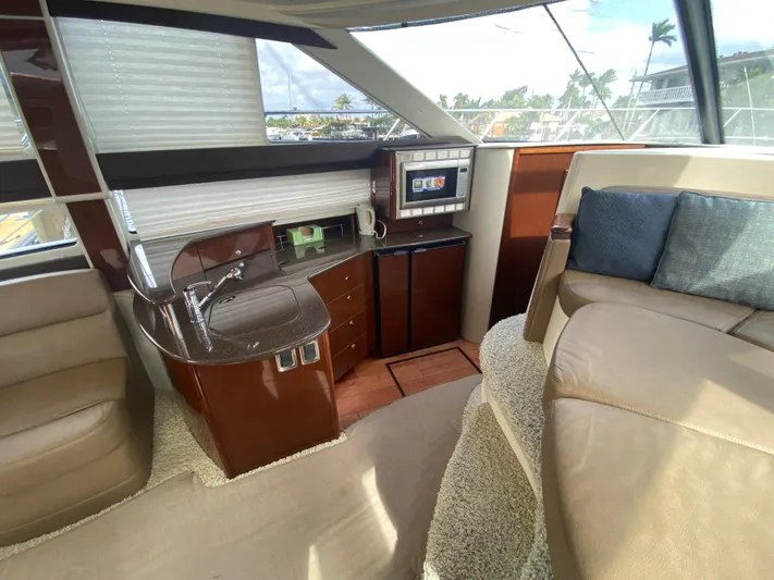 Sea Shack Yacht Photos Pics Luxurious interior of 2013 Meridian 391 yacht with modern kitchenette and seating area.