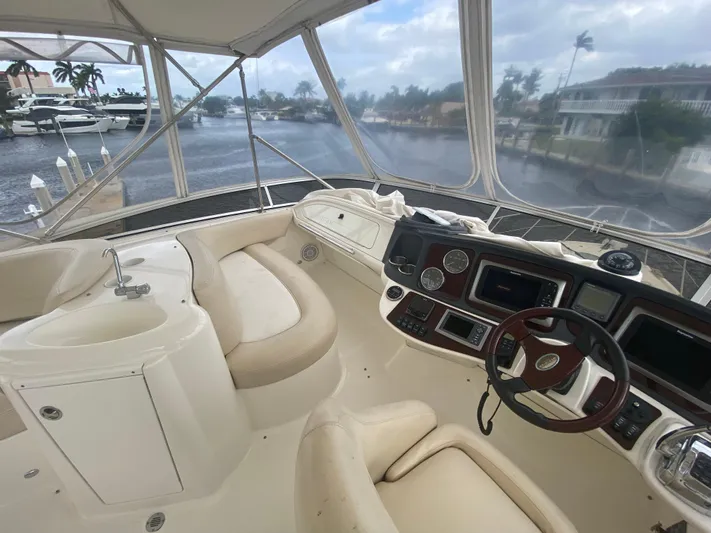 Sea Shack Yacht Photos Pics 2013 Meridian 391 yacht interior with helm, seating, and waterfront view.