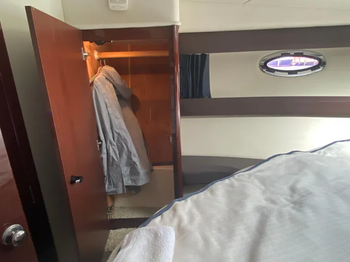 Sea Shack Yacht Photos Pics Interior of 2013 Meridian 391 yacht with open closet and porthole window.