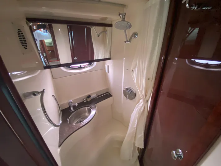 Sea Shack Yacht Photos Pics Compact bathroom in 2013 Meridian 391 yacht with shower, sink, and mirror.