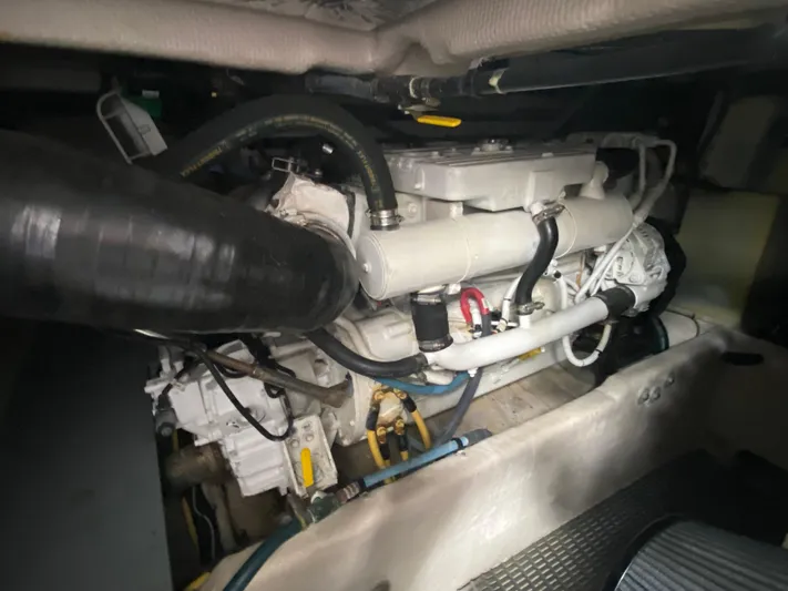 Sea Shack Yacht Photos Pics Engine compartment of a 2013 Meridian 391 yacht, showcasing mechanical components and hoses.