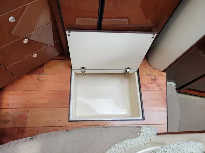 Sea Shack Yacht Photos Pics Open storage compartment on 2013 Meridian 391 yacht with wooden flooring.