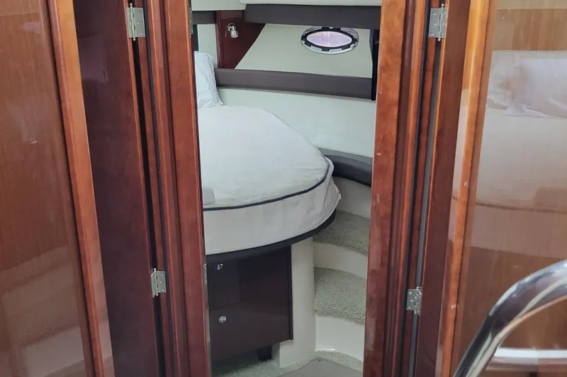 Sea Shack Yacht Photos Pics Interior cabin of 2013 Meridian 391 yacht with cozy bed and wooden finish.