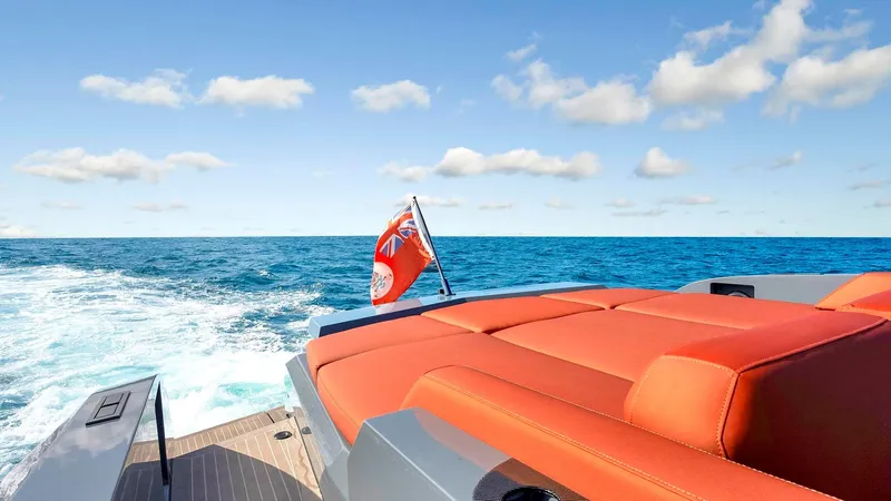 Vesper Yacht Photos Pics Vanquish Yachts VQ 54, 2017 model, cruising on open sea with red seating and flag.