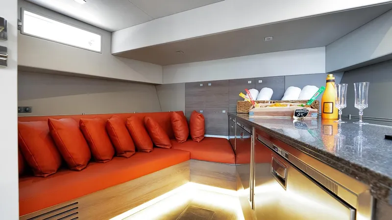 Vesper Yacht Photos Pics Luxurious interior of 2017 Vanquish Yachts VQ 54 with modern seating and kitchenette.