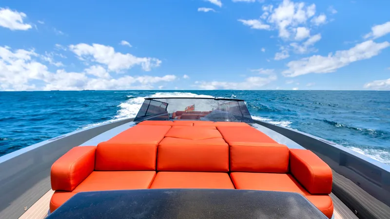 Vesper Yacht Photos Pics 2017 Vanquish Yachts VQ 54 with orange seating cruising on open sea under blue sky.