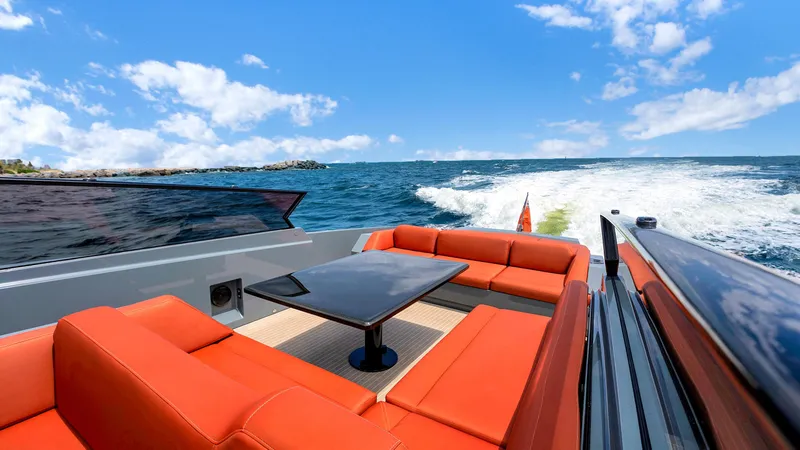 Vesper Yacht Photos Pics Luxurious 2017 Vanquish Yachts VQ 54 with orange seating, cruising on open water.