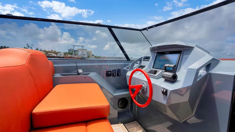Vesper Yacht Photos Pics Interior of 2017 Vanquish Yachts VQ 54 with orange seating and modern dashboard.